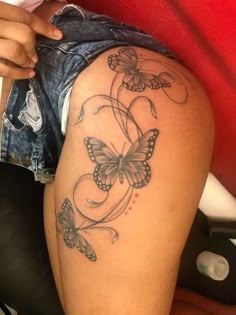 a woman's thigh with butterflies on it