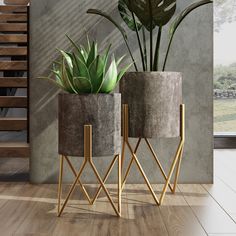 two planters sitting next to each other on top of a wooden floor