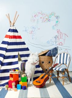 a stuffed animal is next to a teepee tent and other toys on the floor