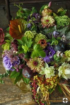 a bouquet of flowers sitting on top of a wooden table