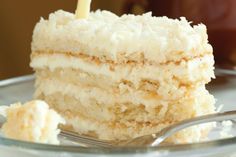 a close up of a piece of cake on a plate with a fork in it