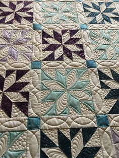 a close up of a quilt on a bed