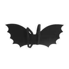 a black bat hanging from the side of a wall