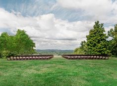 rows of chairs are set up in the middle of a field for an outdoor ceremony