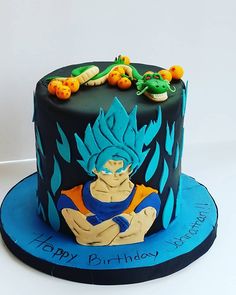 a birthday cake with an image of gohan sitting on top of it, and the words happy birthday written in blue