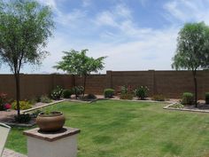 a large yard with grass and trees in it