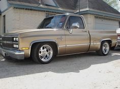 a brown truck parked in front of a house