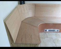 a wooden bench sitting on top of a tiled floor