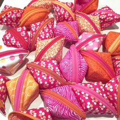 many different types of colorful bags on a white tablecloth with polka dots and circles