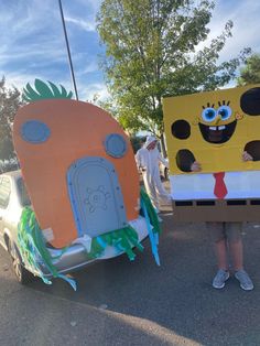 two people in costumes are standing next to each other near a car that is painted like characters from the spongebob movie