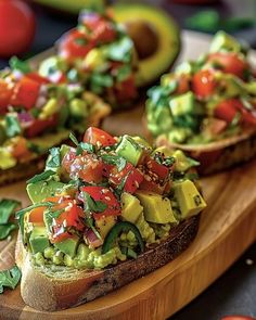 avocado and tomato toast on a cutting board