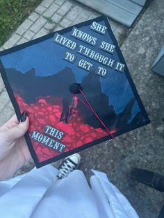 someone is holding up a graduation cap that says she knows she lived through it to get to