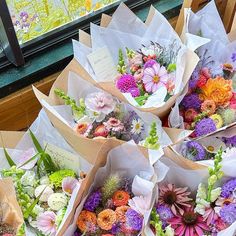 many different types of flowers in paper bags