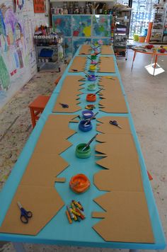 a long table with scissors and bowls on it