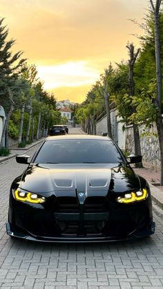 a black car parked on the side of a road