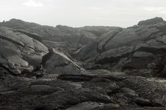 black and white photograph of rocky terrain with sky in the backgroung area