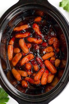 hot dogs are cooked in the crock pot and garnished with ketchup