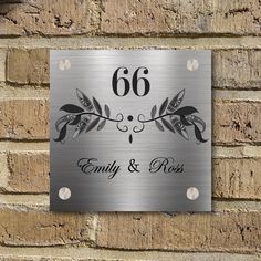 a metal sign with the number sixty and roses on it