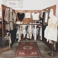 a room filled with lots of clothes and rugs