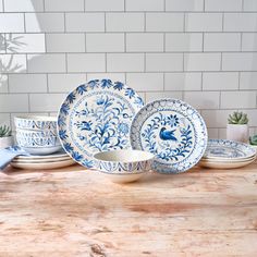 the blue and white dishes are on the table