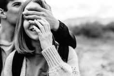 black and white photograph of two people covering their eyes with each other's hands