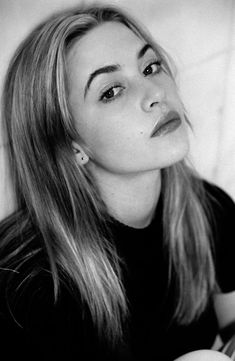 a black and white photo of a woman with long hair