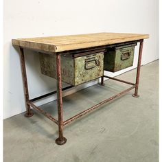 an old metal table with two drawers on one side and another drawer on the other