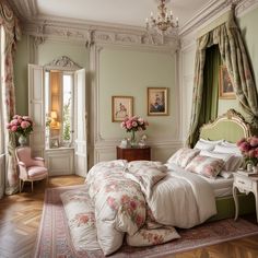 a bedroom with green walls and pink flowers in vases on the bed, chandelier