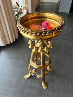 an ornate gold tray with flowers on it