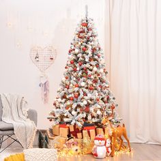 a decorated christmas tree in a living room with presents on the floor next to it