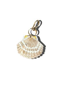 a shell shaped keychain on a white background