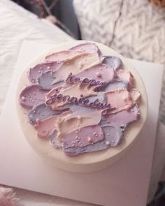 a birthday cake with purple frosting on top