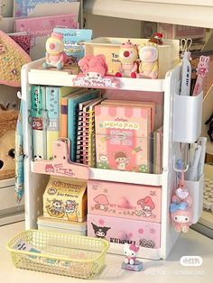 an assortment of stationery items are displayed on a shelf in a room filled with stuffed animals