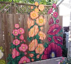 a fence with flowers painted on it