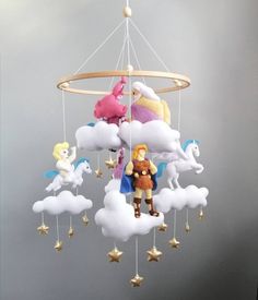 a wind chime with several stuffed animals hanging from it's sides and clouds