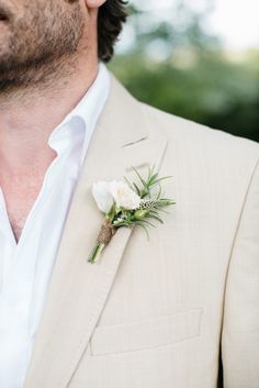 a man in a suit with a boutonniere on his lapel