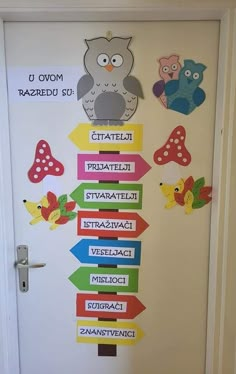 the door is decorated with colorful signs and an owl on it's back side