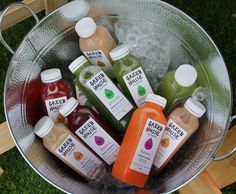 a bucket filled with lots of different types of juice