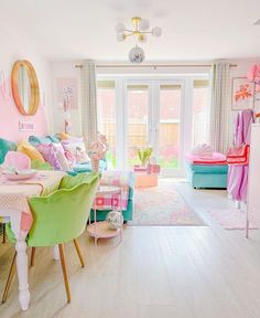 a living room filled with lots of furniture next to a door and window covered in curtains