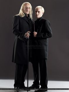 two men dressed in black standing next to each other