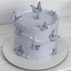 a white cake with blue butterflies on it