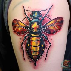 a bee tattoo on the back of a woman's arm, with yellow and red colors