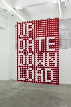 a large red and white sculpture in an empty room