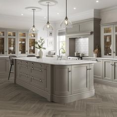 a large kitchen with white cabinets and marble counter tops