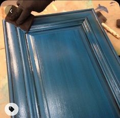 a close up of a blue door being painted