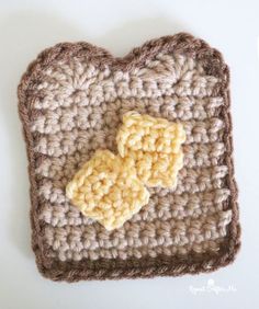 a crocheted square with two yellow flowers on it