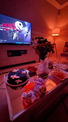 a living room filled with furniture and a flat screen tv sitting on top of a table