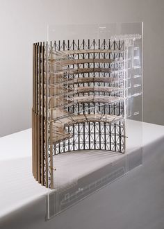 a model of a building made out of wood and plexed with metal bars