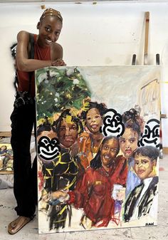 a woman standing next to a large painting with black women on it's sides