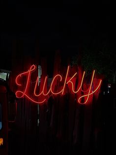 a neon sign that reads lucky in the dark